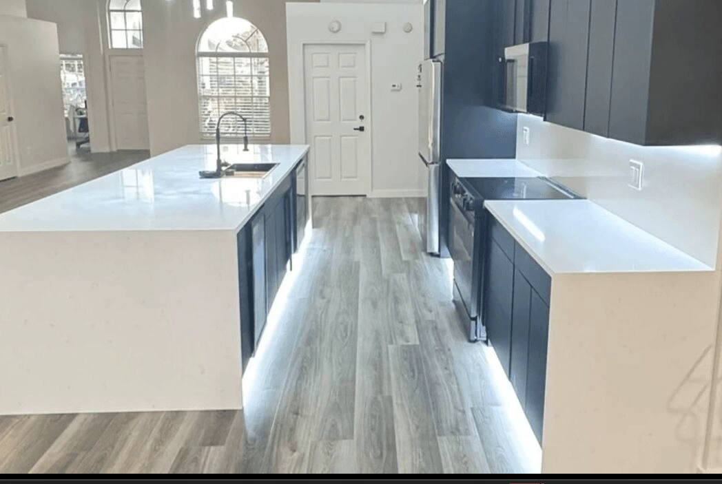Cabinet painting in Tampa, navy kitchen cabinets with white quartz